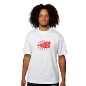 A person with curly hair wears the BEAT THE ODDS S/S TEE WHITE, featuring a bold red B with black flames and star accents, exuding galactic style as they stand facing forward against a plain white background.