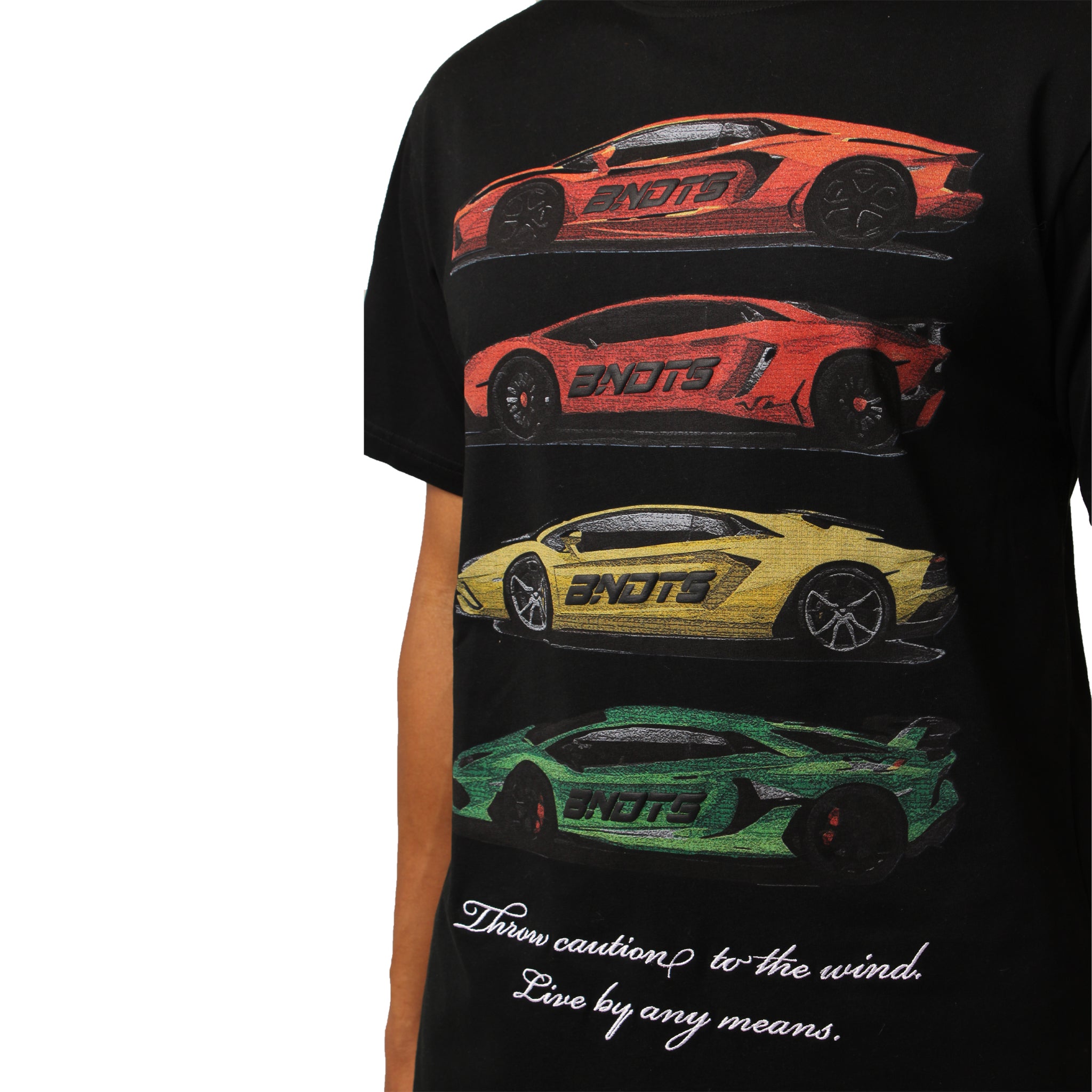 S TEE BLACK is an oversized black T-shirt with puff-printed red, orange, yellow, and green sports cars stacked horizontally. "Throw caution to the wind. Live by any means." appears in white cursive at the bottom.