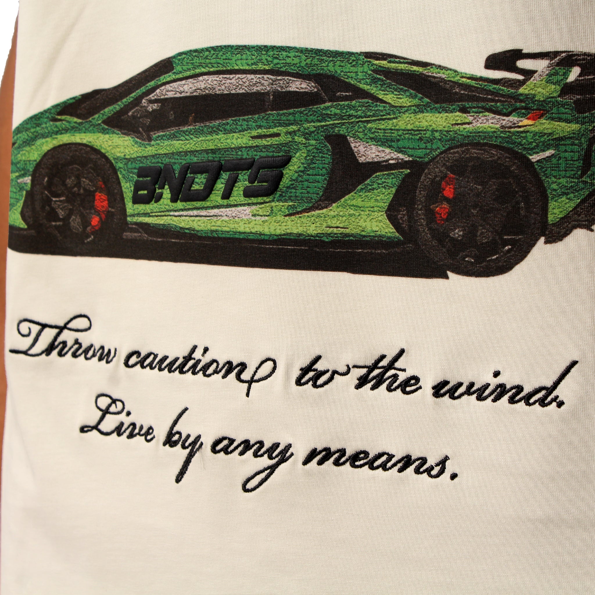 A close-up of the CAUTION TO THE WIND S/S TEE CREME shows a bold embroidered green sports car with "BNOTS" on it and the cursive message: Throw caution to the wind. Live by any means. written below.