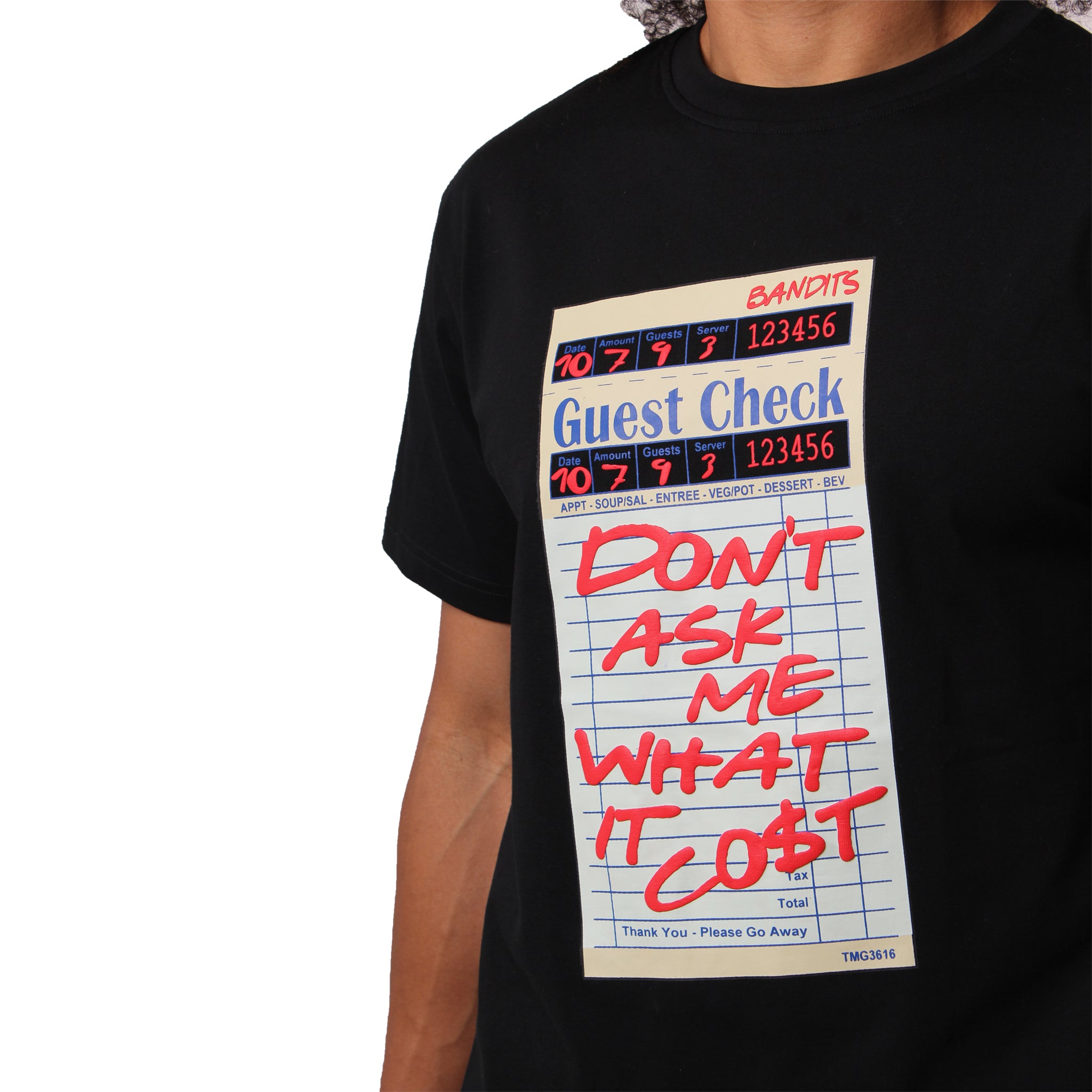 S TEE BLACK, this person sports a black cotton shirt with a bold guest check graphic and "DONT ASK ME WHAT IT COST" in red. The tee’s retro distressed style stands out, though the person's head is partly out of frame.