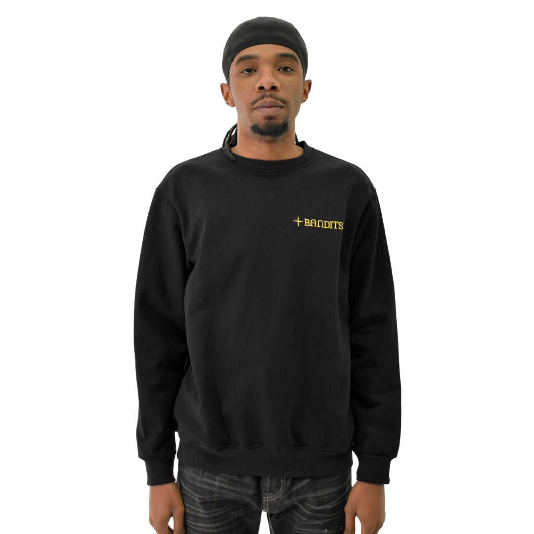 A man stands facing forward against a plain white background, wearing the HAPPY DAYS CREWNECK SWEATSHIRT BLACK with "BANDITS" in yellow text on the left chest.