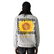 A person with long dreadlocks, in a black cap and the HAPPY DAYS CREWNECK SWEATSHIRT HEATHER GREY, stands facing away. The gray heavyweight fleece features bold "happiness" and "BANDITS" text on the back with a sunflower graphic.