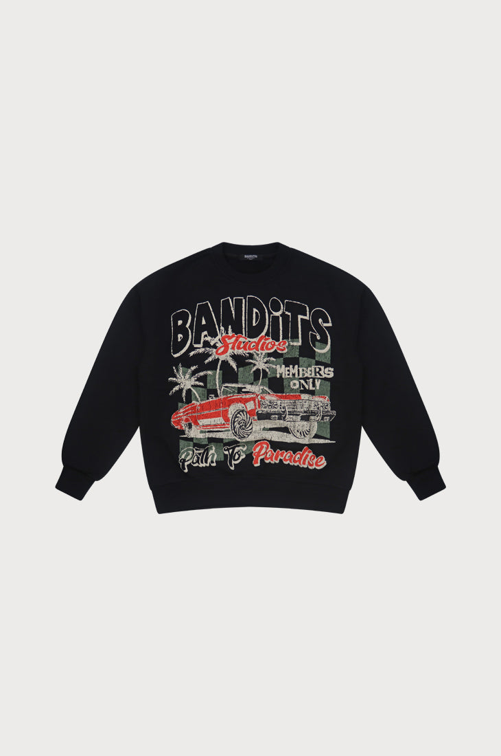 The PATH TO PARADISE CREWNECK SWEATSHIRT BLACK is an oversized black crewneck with a red vintage lowrider, palm trees, and "BANDITS," "Members Only," "Studio," and "Path to Paradise" text—a bold streetwear statement.
