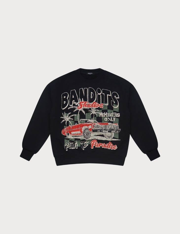 The PATH TO PARADISE CREWNECK SWEATSHIRT BLACK is an oversized black crewneck with a red vintage lowrider, palm trees, and "BANDITS," "Members Only," "Studio," and "Path to Paradise" text—a bold streetwear statement.