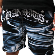 A person is wearing IRIDESCENT MESH SHORTS BLACK, featuring a black and white pattern and double-layered mesh, with "BANDITS" and stars printed in stylized white letters across the true-to-size waistband. Their hands are at their sides.