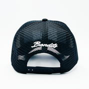 A black mesh trucker hat, seen from the back, featuring an adjustable snapback and "ONLY THE STRONG SURVIVE TRUCKER" in bold white 3D embroidery above the opening.