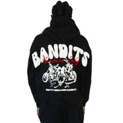 A person with long braids wears the BIKER CLUB PULLOVER HOODY BLACK, a heavyweight fleece hoodie with bold white BANDITS text, red Members Only script, "Pretty Girls Love Bandits," and a back graphic of women and motorcycles.