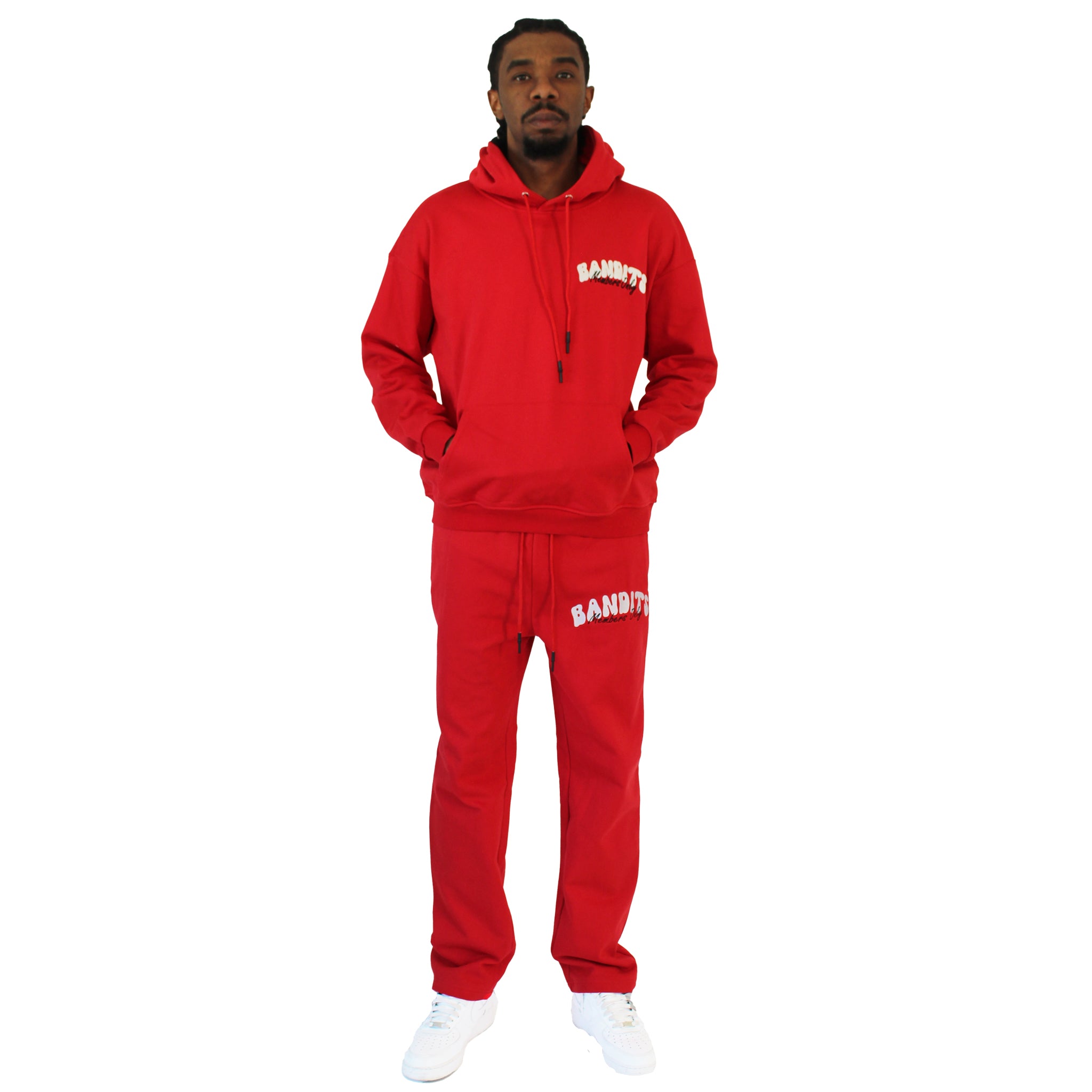 A man faces forward in a red BIKER CLUB PULLOVER HOODY and matching red sweatpants with white BANDITS text, paired with white sneakers, standing against a plain white background.