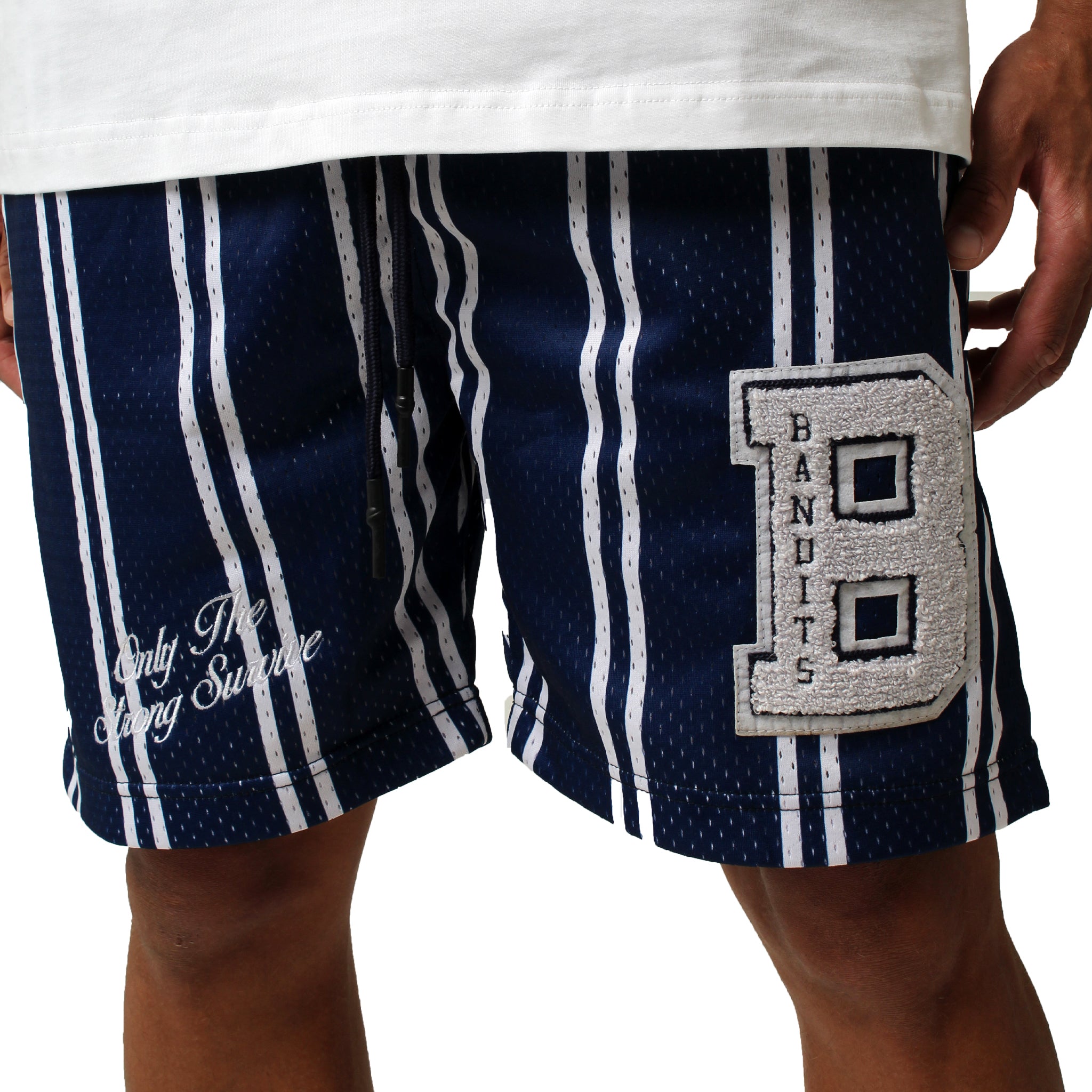 Wearing ONLY THE STRONG SURVIVE MESH SHORTS NAVY, which feature navy and white stripes, a double-layered mesh design, a large chenille “BANDITS” patch, and cursive “Only The Strong Survive” text on the left leg. Fit is true to size.