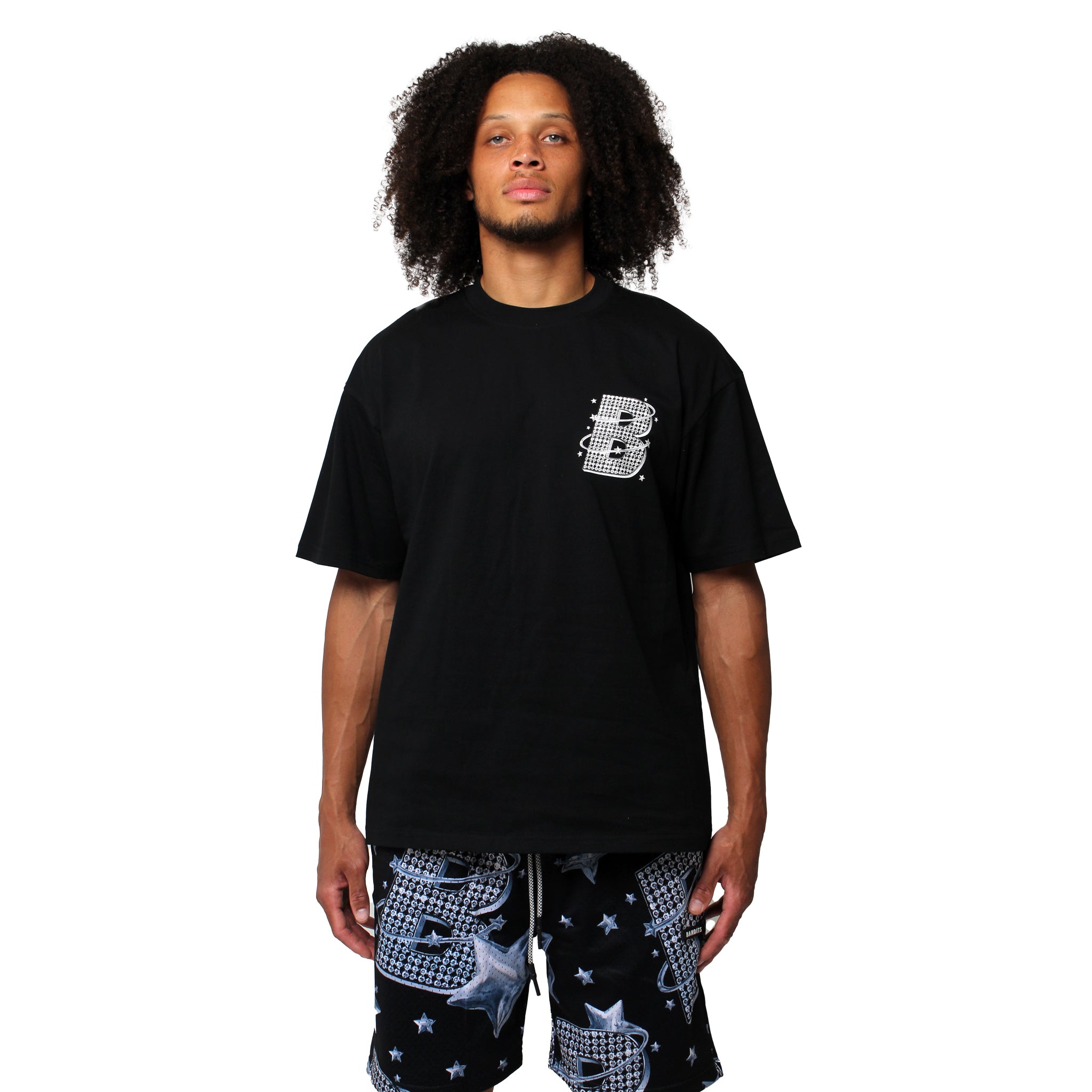 S TEE BLACK, a streetwear T-shirt with a white patterned letter B, and black shorts decorated with stars and matching B graphics, standing against a white background.